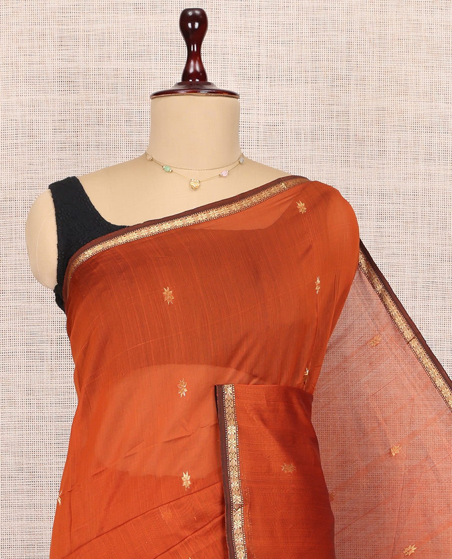 Orange Maheshwari Cotton Saree, Adorned with Buttas, a Subtle Contrast Piping Border, Pallu Gleamed Up with Zari Buttas, and a Contrast Blouse