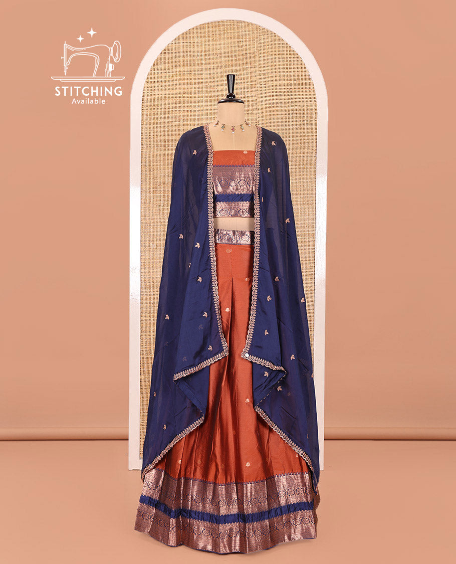 Rust and Blue Semi-Banarasi Half-Saree Featuring Zari Buttas Skirt, Complemented by Contrast Rettai Pettu, Traditional Border of Floral Creeper Designs, Paired with a Matching Blouse, and a Satin Georgette Embroidered Scallop Dhavani