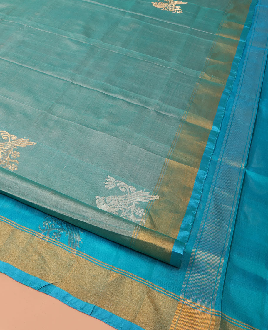 Blue Uppada Silk Saree Accentuated with Parrot Zari Buttas, Complemented by Bavanji Border, Contrast Pallu Steeped with Parrot Zari Designs, and Paired with a Contrast Blouse