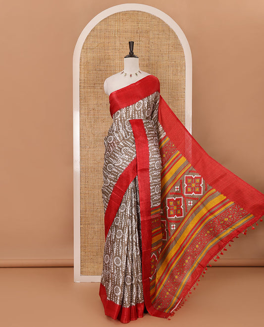 Brown batik-style printed khadi cotton saree, contrast plain border, patola printed pallu & contrast plain blouse