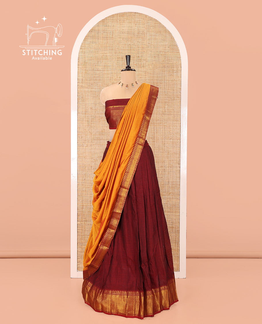 Maroon Mercerised Cotton Half-Saree Features Plain with Contrast Traditional Zari Temple Bordered Skirt, Paired with a Matching Blouse, and Comes with a Contrast Zari-Bordered Dhavani