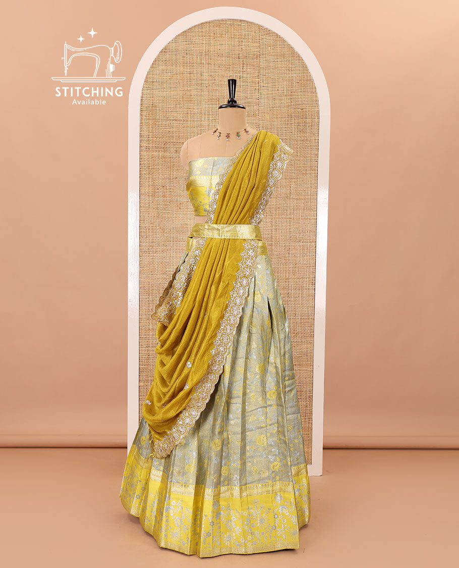 Grey banarasi half-saree, floral jaal thread weave with contrast floral thread bordered skirt, a matching blouse, and scallop embroidered dhavani with belt