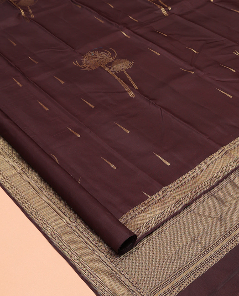Coffee Brown Vasundhara Silk Saree Decked Up with Thazampoo Rekku Buttas and Vel Buttas, Highlighted with a Zari Border of Manga, Muthu, Kathir, Neli, and Vanki Designs, Subtly Sparkled Pallu of Jaal Design, and Paired with a Matching Blouse
