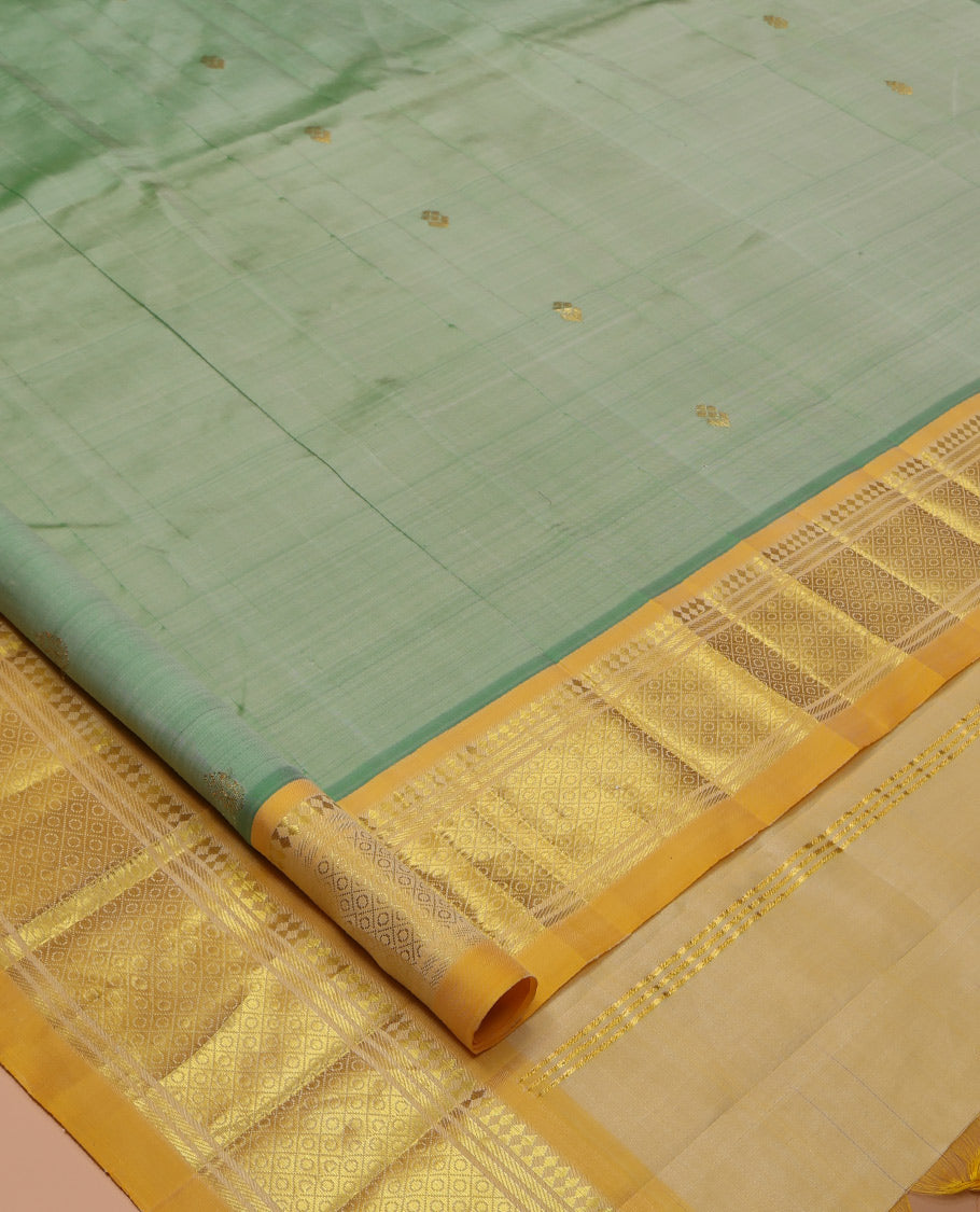 Green Kanchipuram Silk Saree, Woven with Zari Buttas, a Contrast One-Sided Border of Panner Sombu, Banaras, and Jaal Designs, Floral Creeper Pallu, and No Blouse