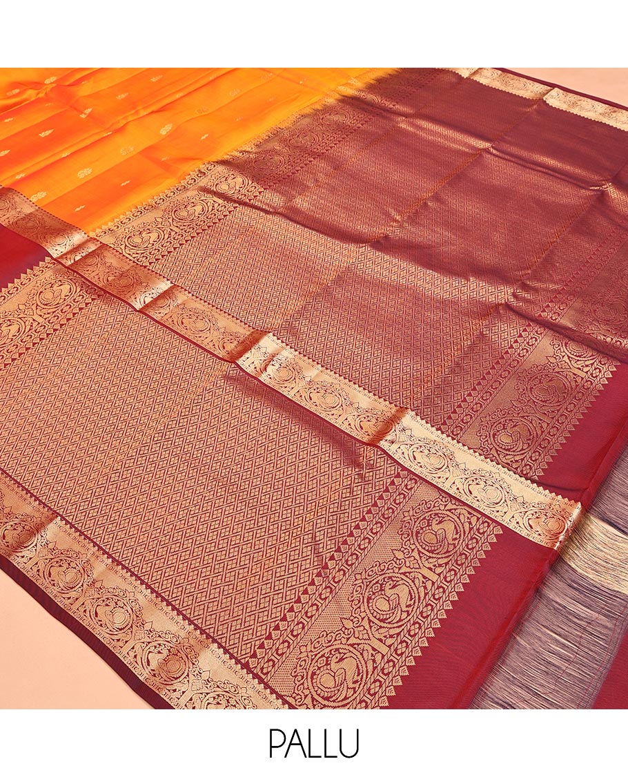 Orange Vasundhara Lite Silk Mix Saree, Subtly Sparkled with Zari Buttas All Over Its Body, Complemented by a Contrast Border of Thilakam, Kamalam, and Round Mayil Designs, Intricately Designed Pallu, and Paired with a Contrast Blouse