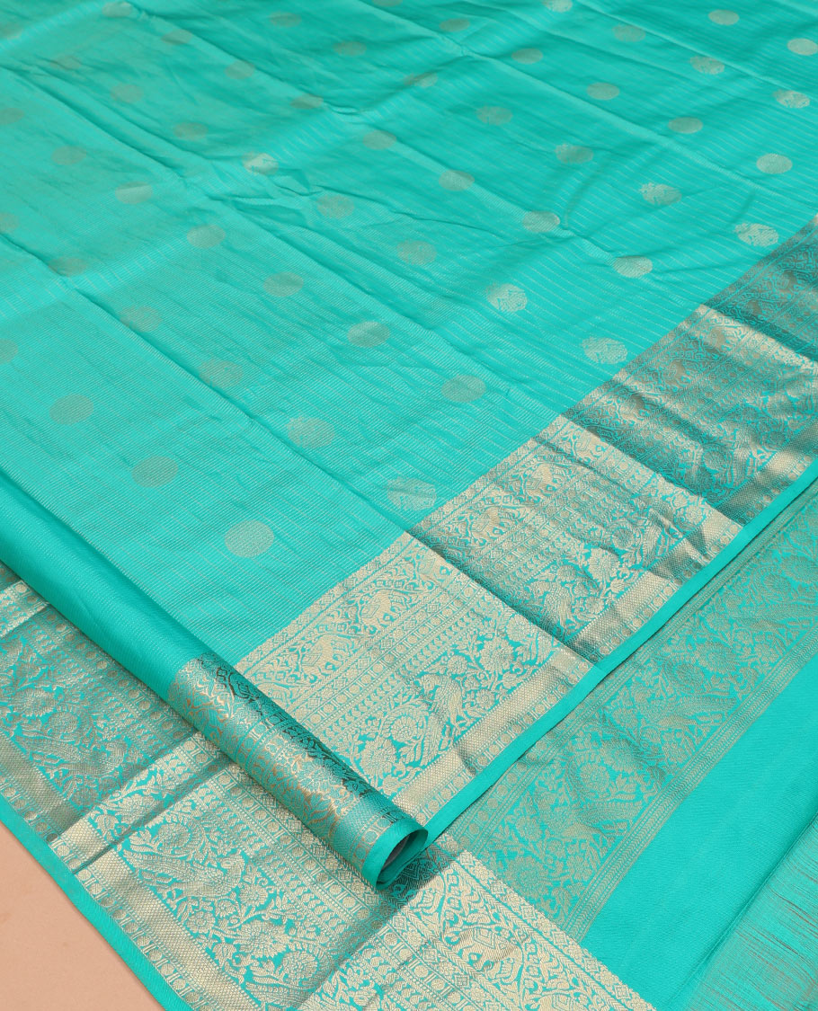 Blue Vasundhara Silk Saree, Accentuated with Zari Buttas and Stripes, a Zari Border of Kathir, Yaanai, Rudraksham, Manga, and Mayil Design, a Grand Pallu, and a Matching Blouse