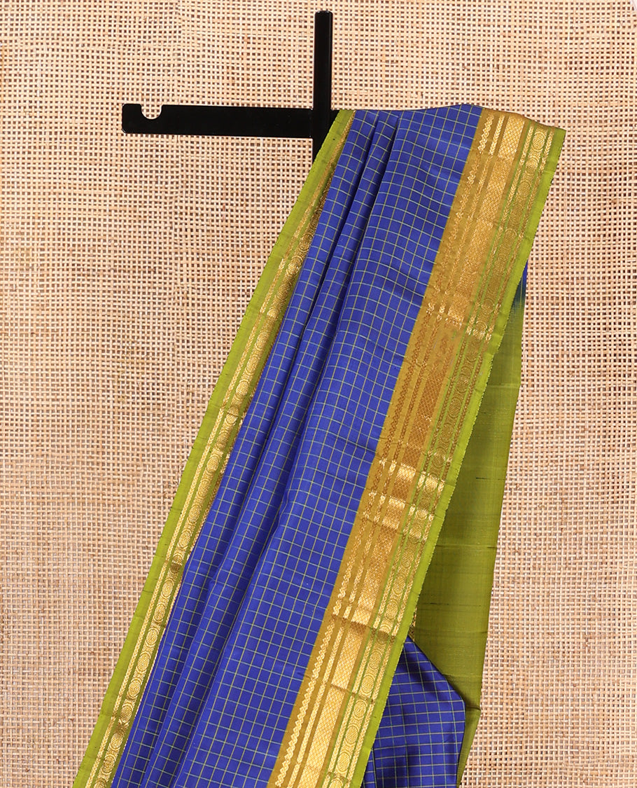 Blue checked Kanchipuram silk saree, contrast border of salngai, kathir, mayil kann, and mayil kann designs, and zari striped pallu
