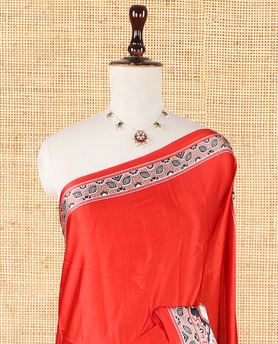 Red half-&-half style modal satin saree features floral & geometric design Ajrakh printed contrast border & pallu