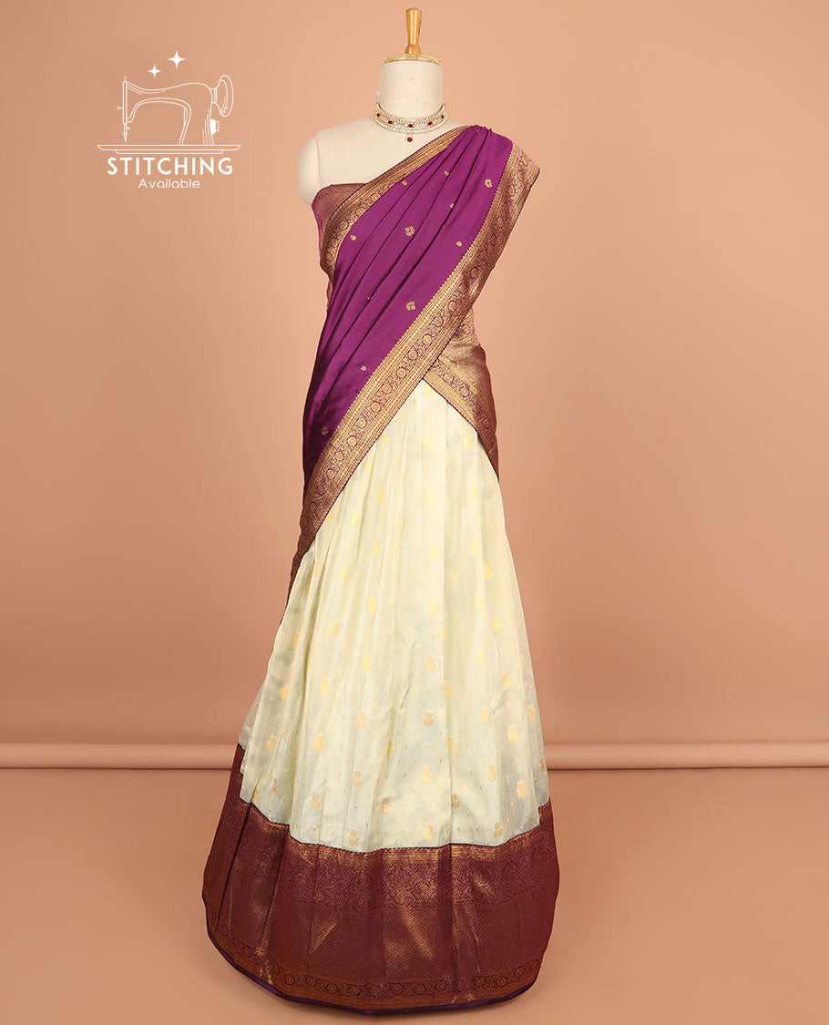 Cream buttas half saree with contrast zari design border, zari design blouse & purple floral vine zari design dhavani
