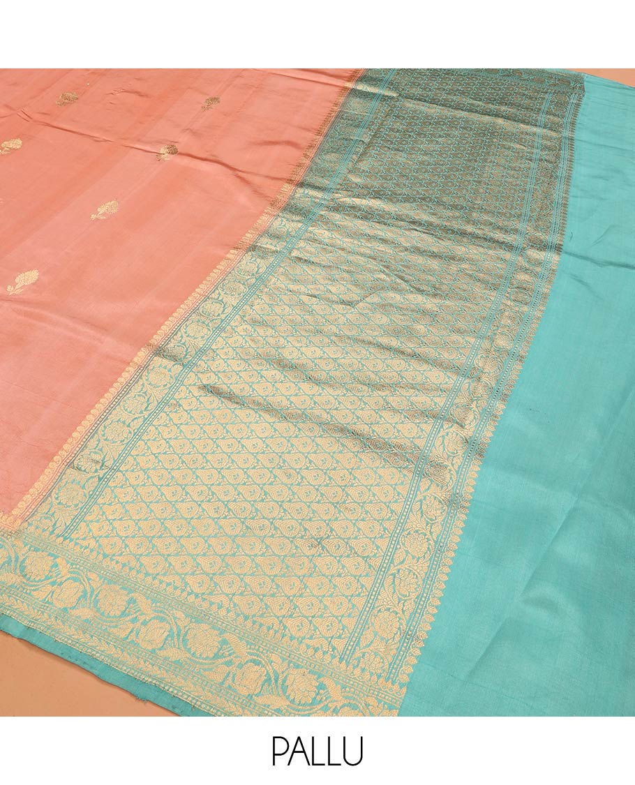 Peach Raw Mango Silk Saree Bedecked with Buttas, Features a Contrast floral creeper design Border, adorned with intricately designed Pallu, and comes with a Contrast Blouse