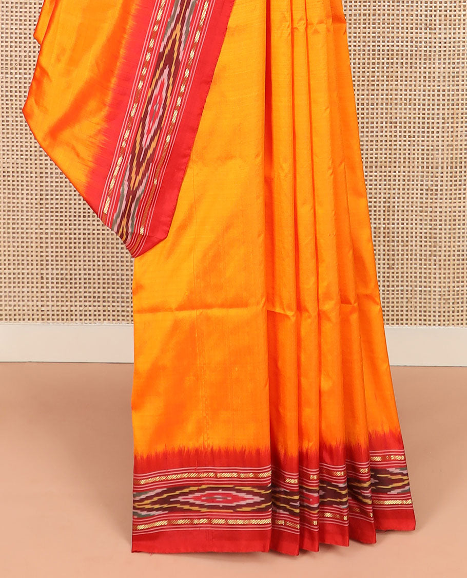 Orange Plain Ikkat Silk Saree with a Contrast Red Border Adorned by a Hazy Ikkat Weave, Featuring a Pallu Flanked by Stripes and Ikkat Texture