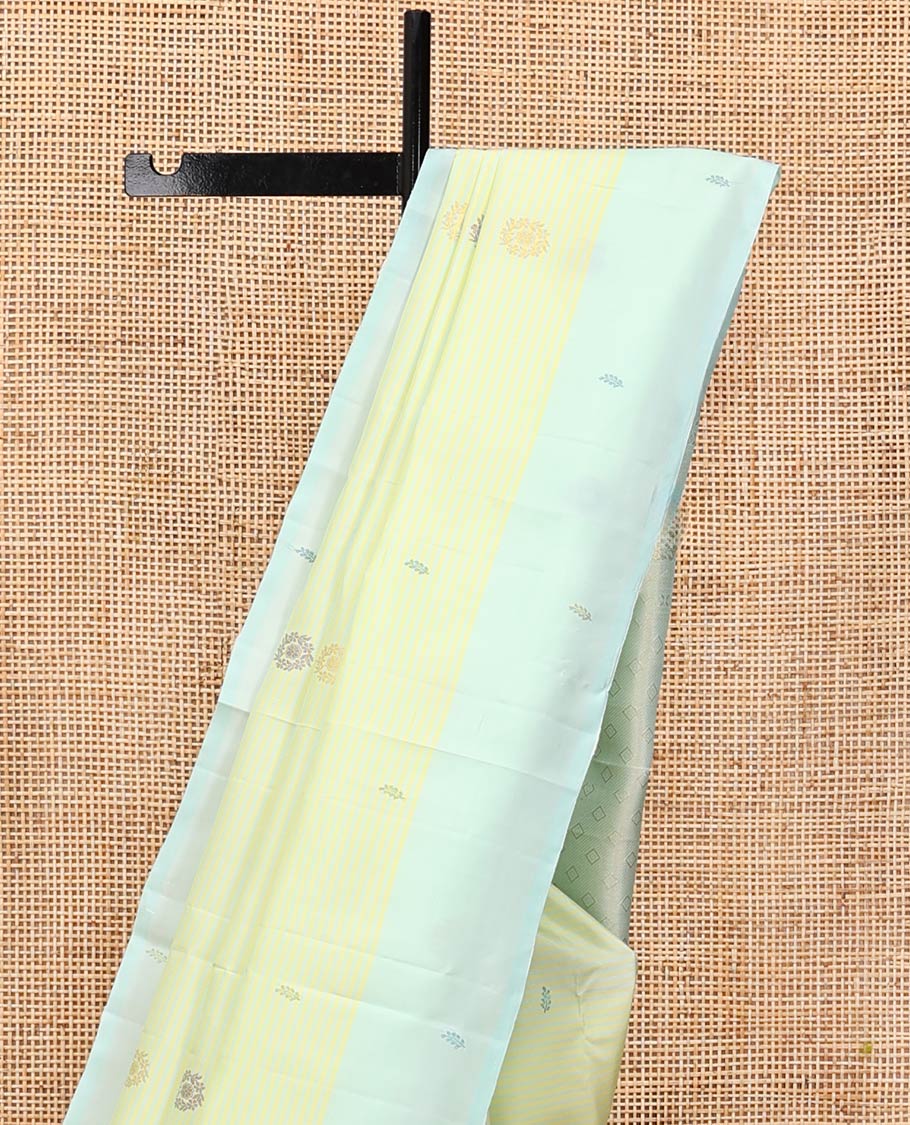 Green Kanchipuram Silk Saree, Subtly Sparkled with Stripes and Thread Buttas, Complemented by a Contrast Border, Jaal Pallu, and Contrast Blouse