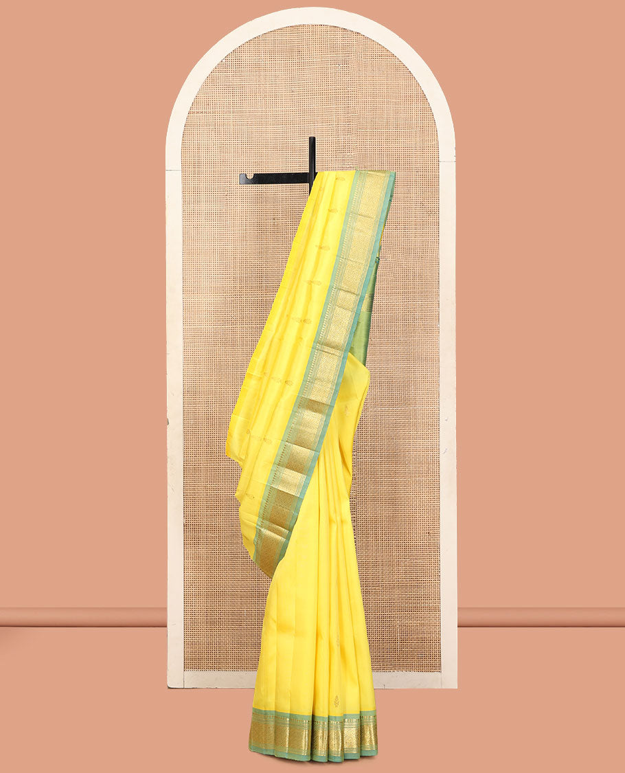 Yellow Kanchipuram Silk Saree, Sparsely Sparkled with Zari Buttas, a Contrast One-Sided Border of Panner Sombu, Banaras, Muthu, and Jaal Designs, a Zari Design Pallu, and No Blouse