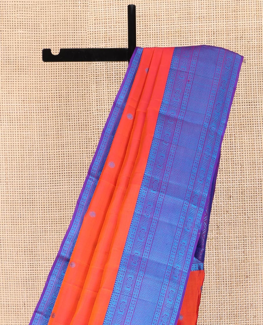 Orange Kanchipuram Silk Saree, Bedecked with Mayil and Chakram Thread Buttas on Its Body, Complemented by a Contrast Border of Rekku, Kamalam, Poun, Chakram, Kuyil Kann, and Then Kuli Kann Designs, Jaal Design Pallu, and Paired with a Contrast Blouse