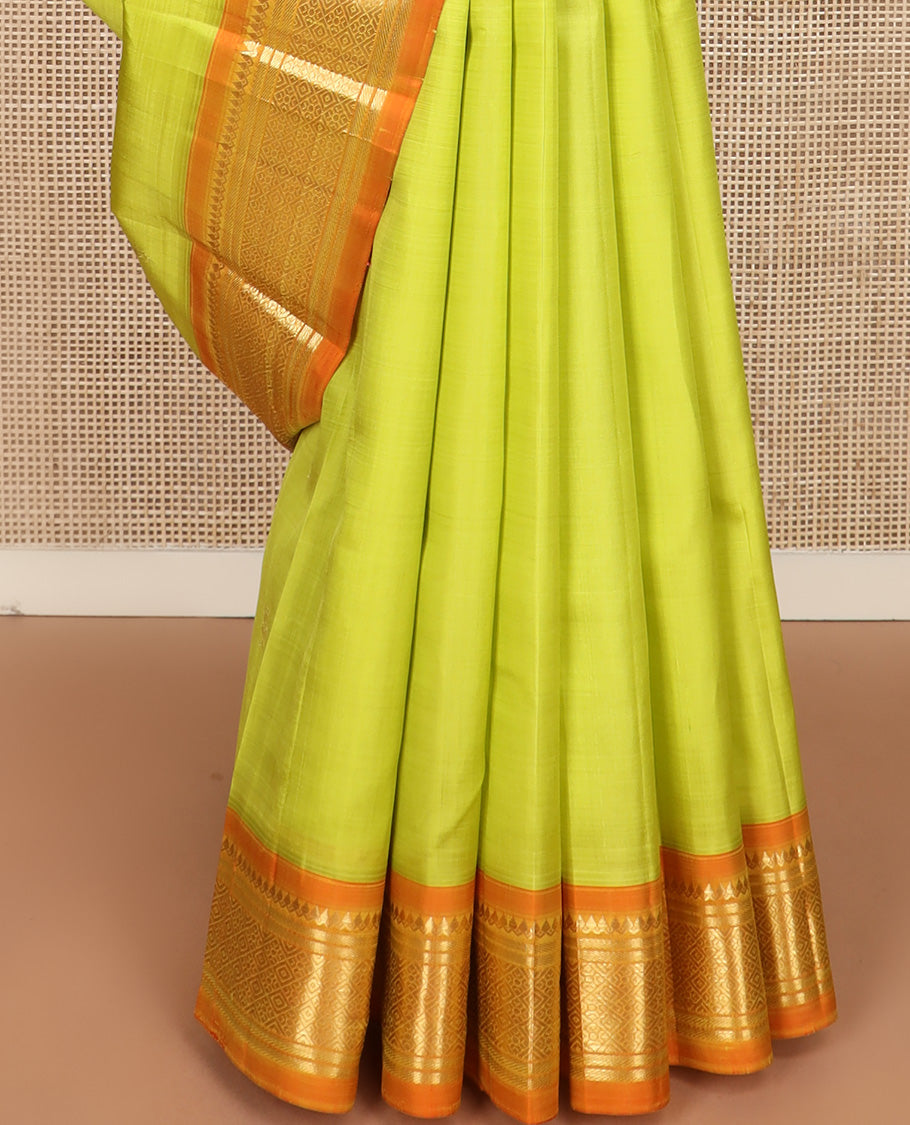 Green zari buttas Kanchipuram silk saree, contrast one-sided korvai border of thilakam mokku, banaras, and jaal design, and zari design pallu