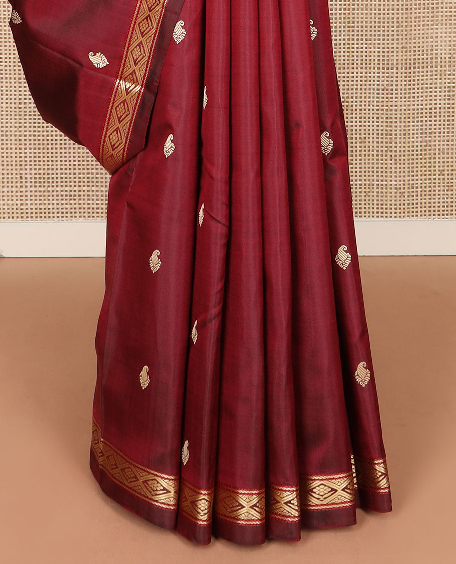 Maroon buttas Kanchipuram silk saree, self-border of diamond designs, and jaal pallu