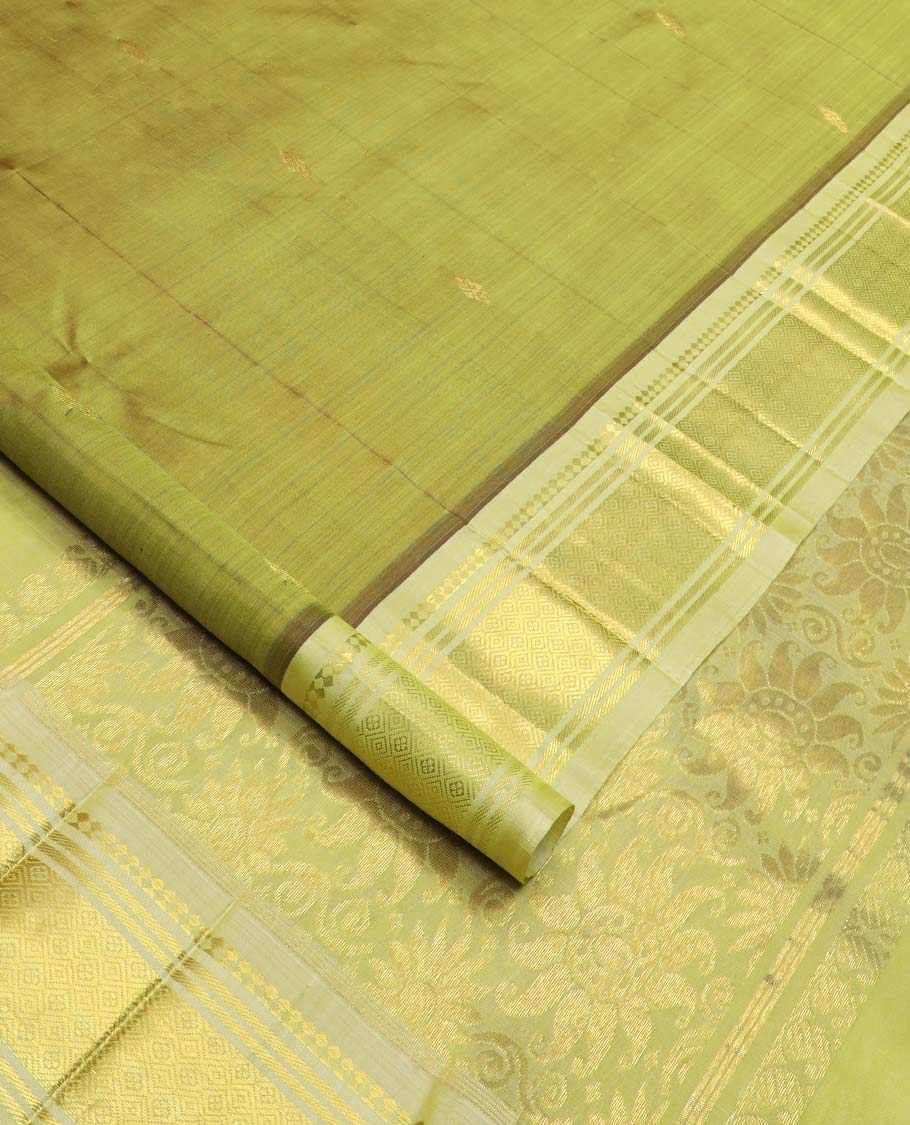 Green zari buttas Kanchipuram silk saree, contrast one-sided border of paneer sombu, banaras, and jaal designs, and floral design pallu