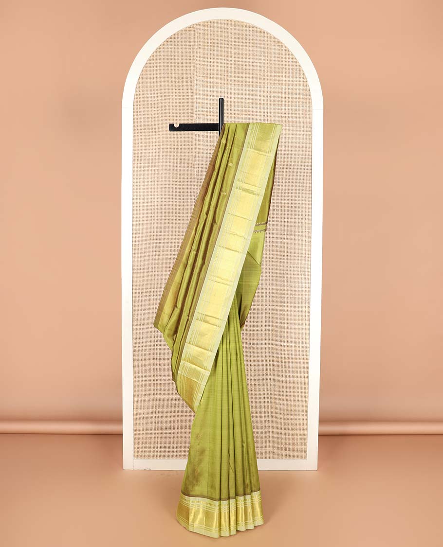 Green zari buttas Kanchipuram silk saree, contrast one-sided border of paneer sombu, banaras, and jaal designs, and floral design pallu