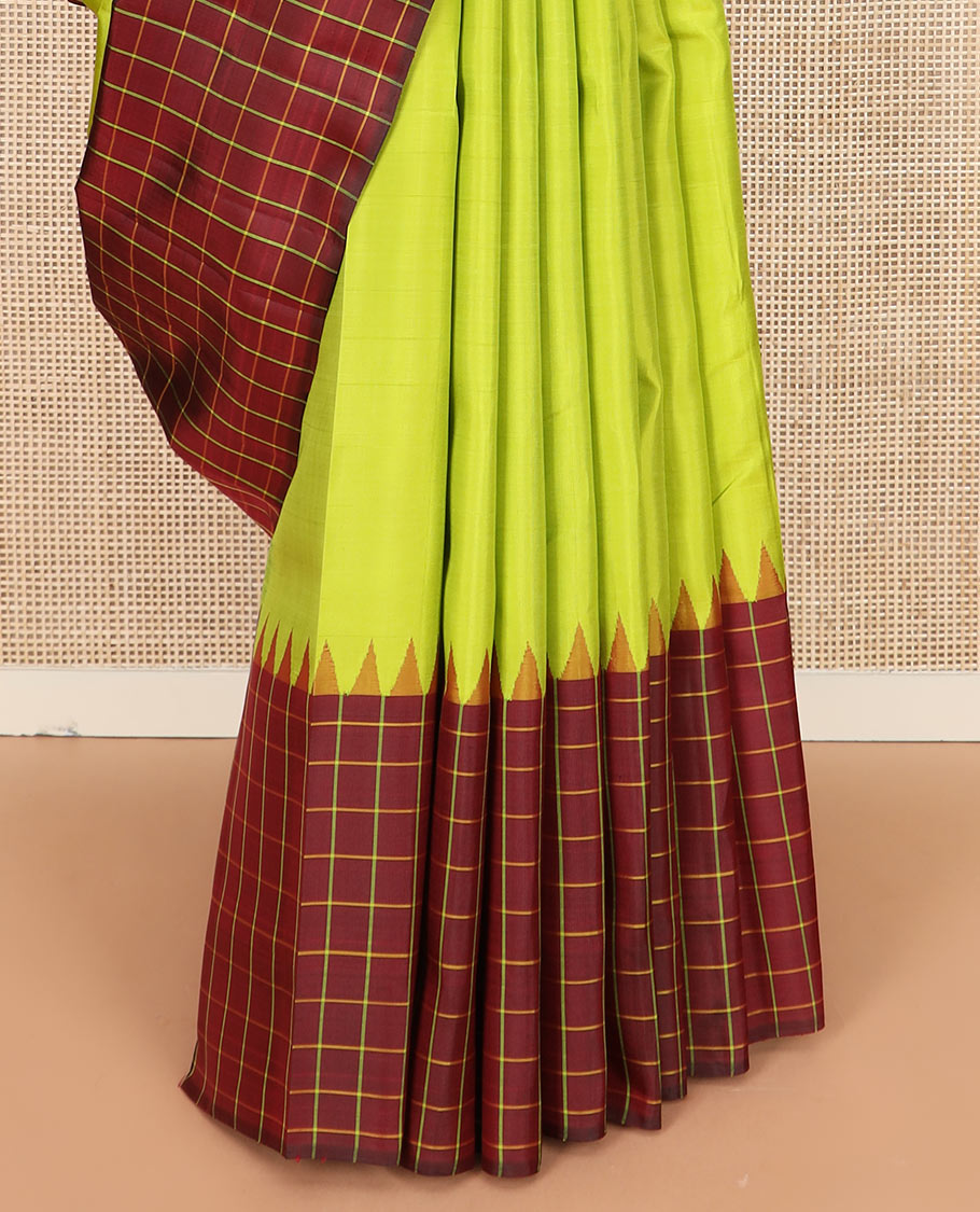 Leaf green plain Kanchipuram silk saree, contrast thazampoo rekku checked border, and checked pallu