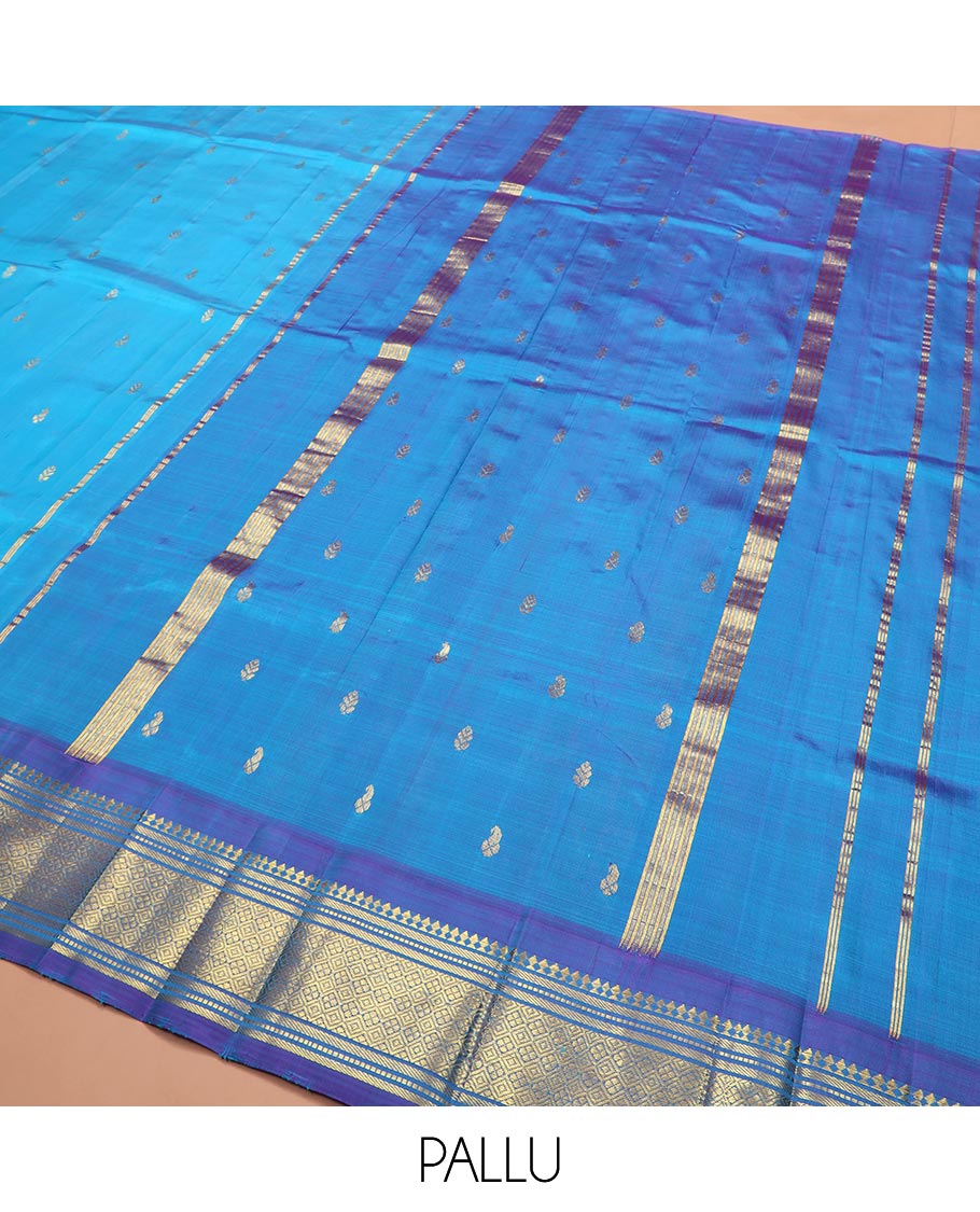 Blue Kanchipuram Silk Saree Enthralled with Zari Buttas All Over Its Body, Complemented by a Contrast One-Sided Border of Paneer Sombu, Banaras, Muthu, and Jaal Designs, Zari Design Pallu, and Comes Without a Blouse