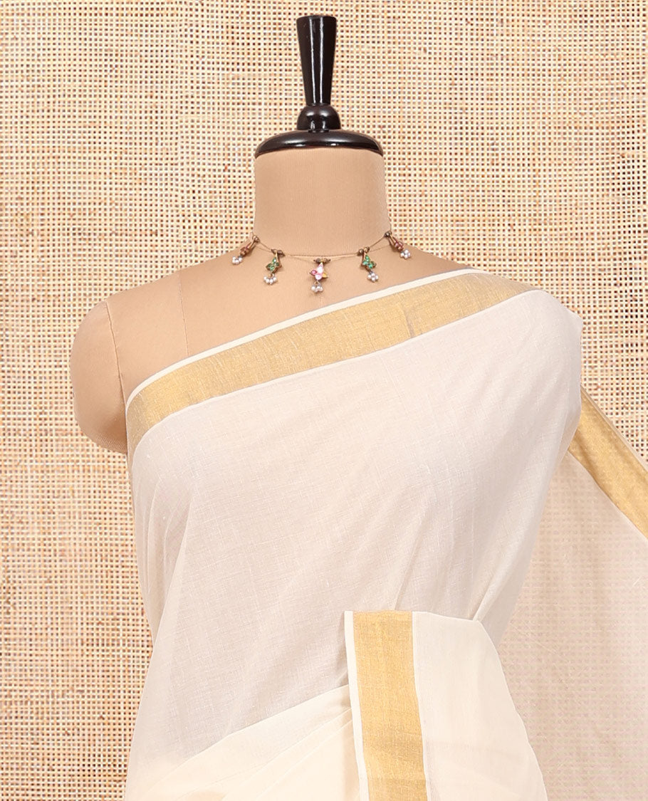 Cream Kerala Cotton Saree, Embellished with Zari Stripes All Over Its Body, a Subtle Bavanji Border, Pallu of Floral-Paisley Designs, and Paired with a Matching Blouse