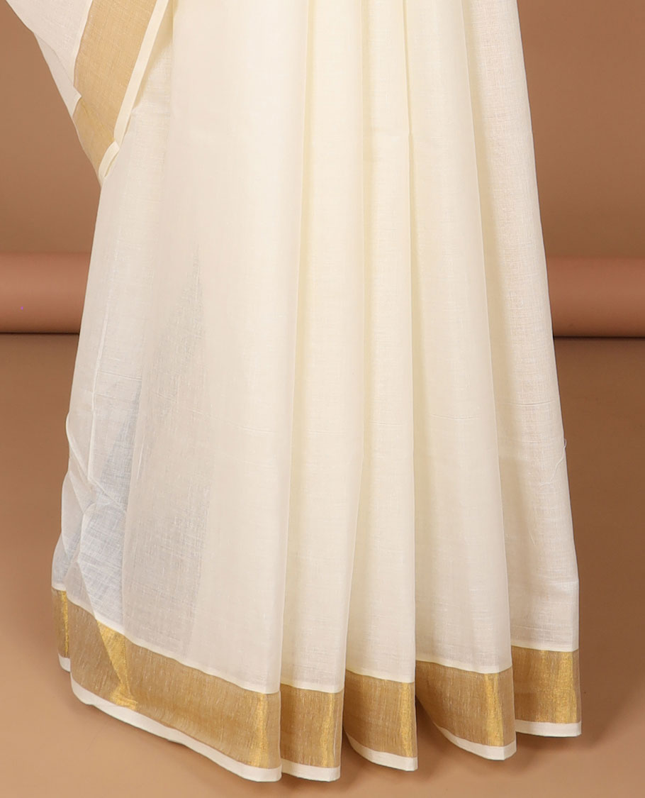 Cream kerala saree with zari designs, zari border & pallu of peacock designs