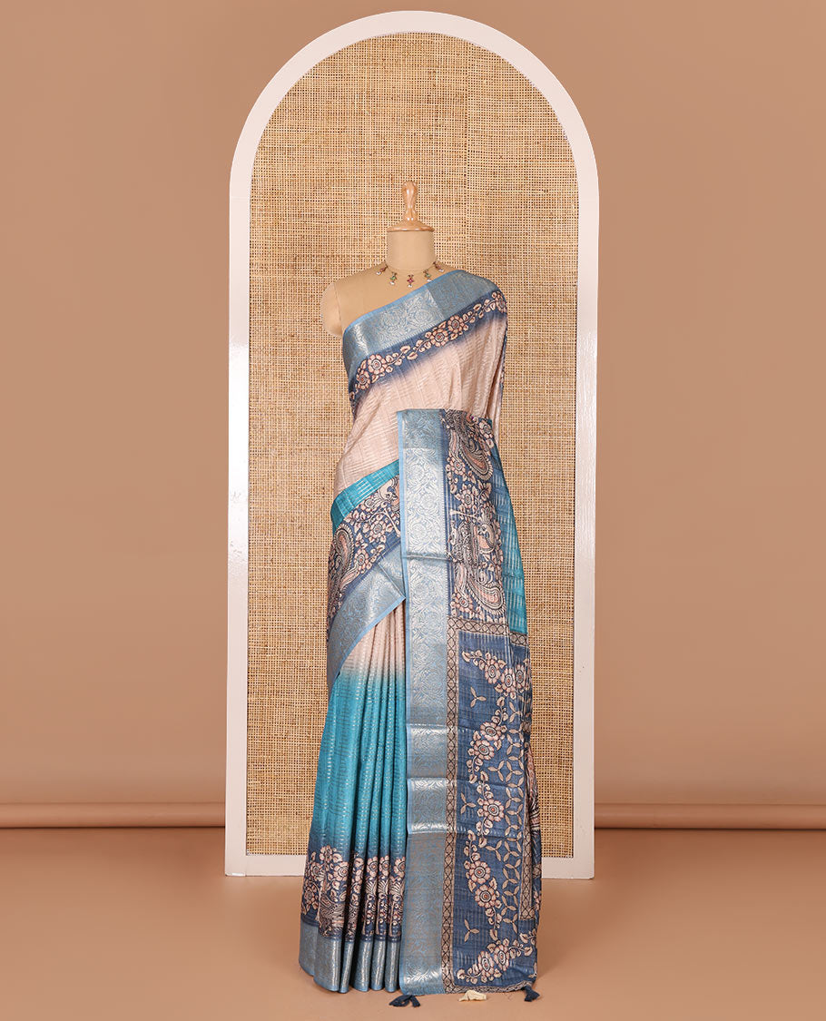 Blue tri-ombre colored zari stripes, and kalamkari peacock printed semi-tussar saree, contrast floral creeper zari border, peacock printed pallu, and a contrast blouse of zari and print work