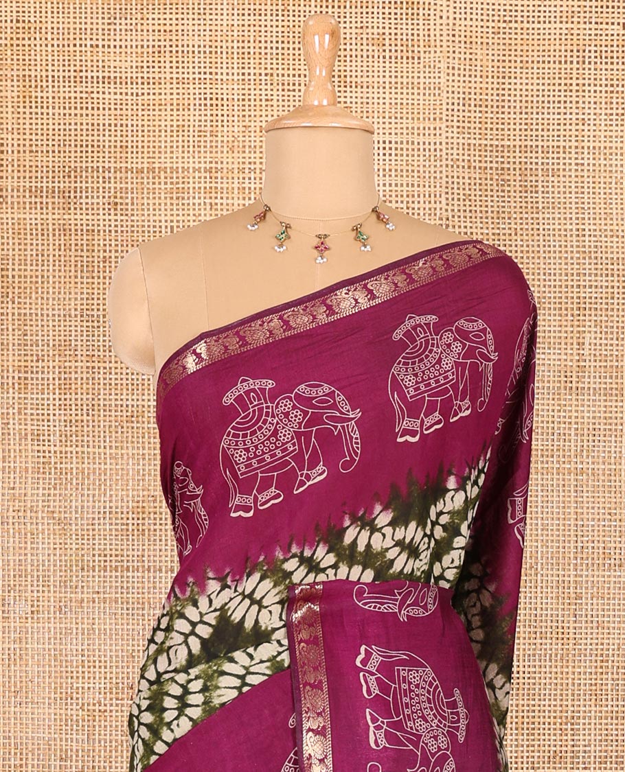 Green shibori printed muslin cotton saree, contrast zari border of elephant motifs print, big elephant printed pallu, and a contrast printed blouse