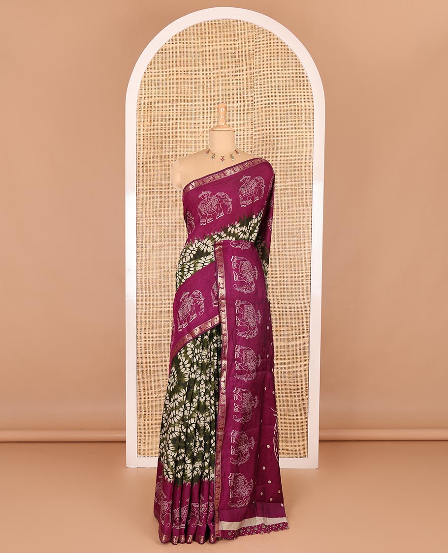 Green shibori printed muslin cotton saree, contrast zari border of elephant motifs print, big elephant printed pallu, and a contrast printed blouse