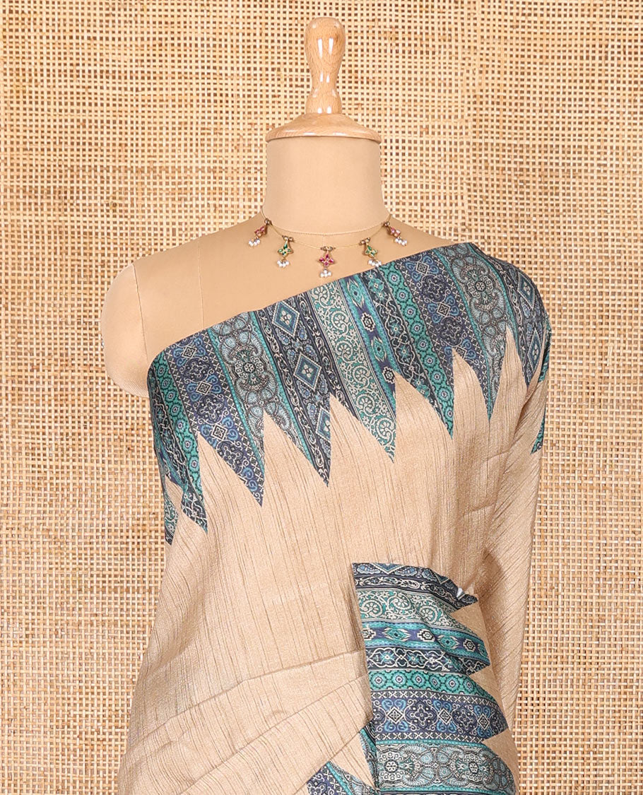 Chikku and blue plain Khicha Tussar saree, temple border of intricate Ajrakh print, Ajrakh printed pallu, and contrast Ajrakh printed blouse