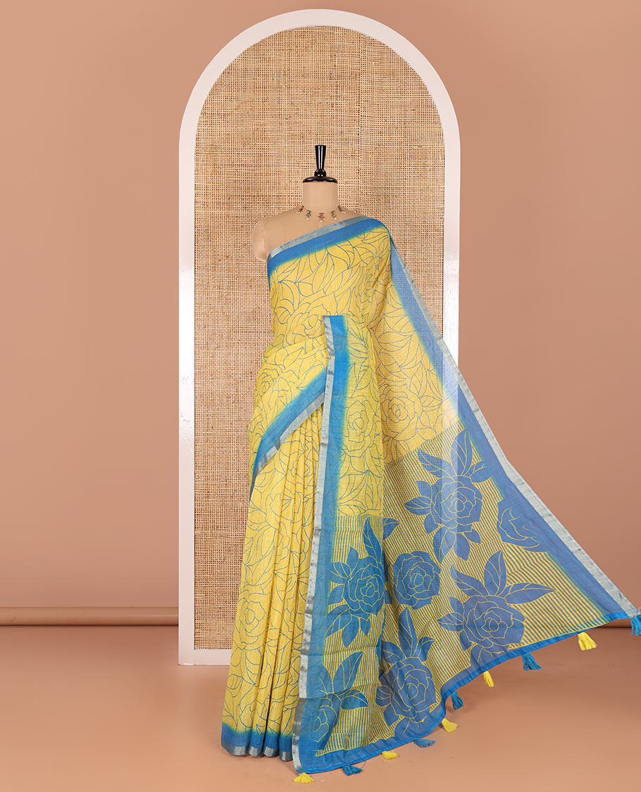 Yellow rose floral printed linen cotton saree, contrast piping border, rose floral printed pallu, and a contrast leaf motifs printed blouse