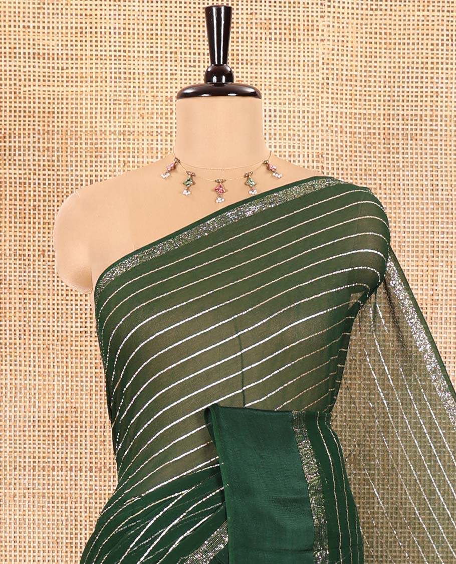 Green Viscose Georgette Saree Gleamed with Horizontal Golden Zari Stripes All Over Its Body, by a Satin Plain Border, a Self Pallu Featuring the Same Horizontal Stripes, and Paired with a Running Blouse