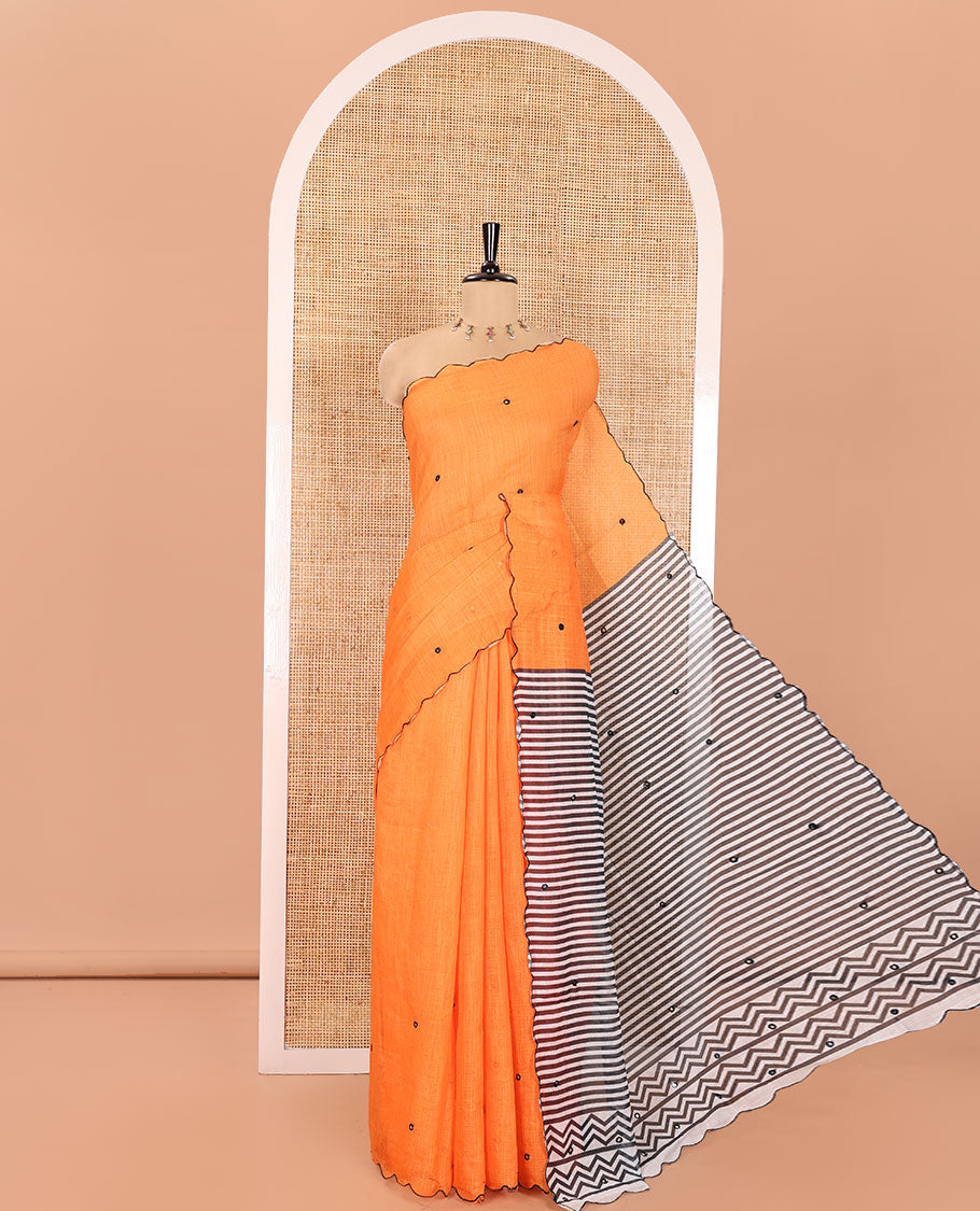 Orange Linen Cotton Saree, Subtly Sparkled with Mirror Work All Over Its Body, Subtly Scallop Border, Complemented by Contrast Pallu of Stripes and Mirror Work, and Paired with a Contrast Geometric Printed Blouse