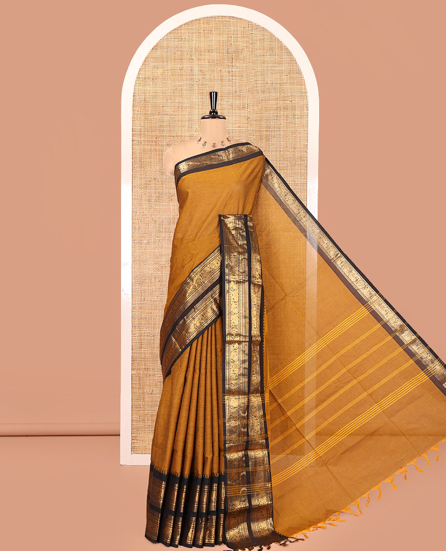 Mustard Plain Chettinad Cotton Saree, Complemented by a Contrast Rettai Pettu Zari Border of Thread-Temple, Coin, Elephant, and Peacock Designs, Subtly Striped Pallu, and Paired with a Matching Blouse