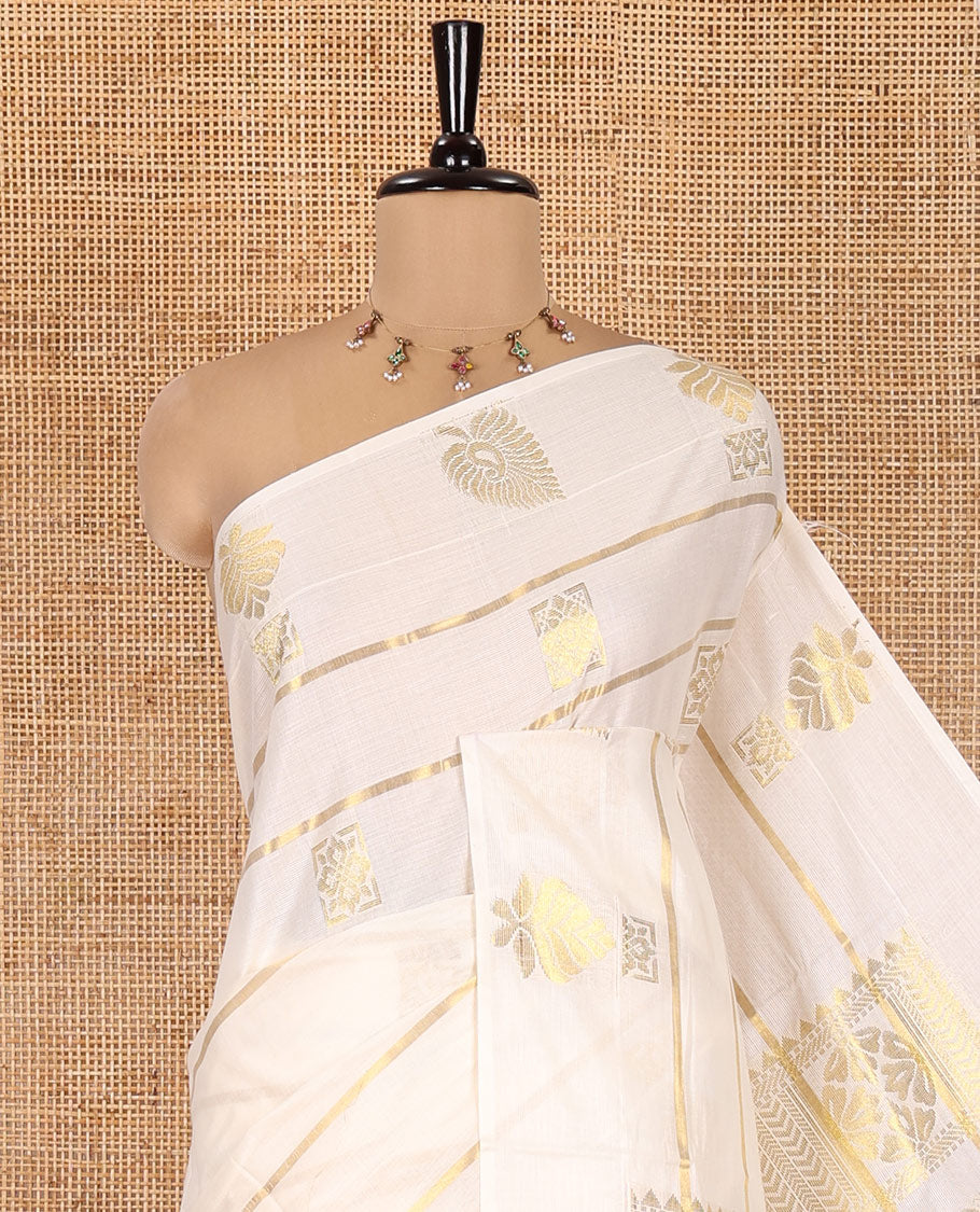 Cream Kerala Cotton Saree, Delicately Woven with Zari Stripes and Buttas, Highlighted by an Intricate Pallu and a Matching Blouse