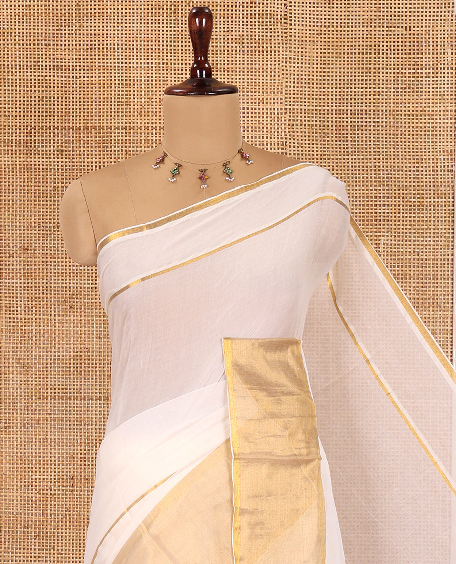 Cream Plain Khadi Mul Cotton Saree, Golden Zari Border, a Self-Pallu with Tassels, and No Blouse