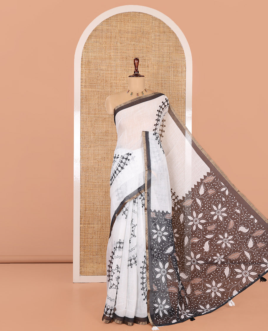 White Linen Cotton Saree Features Warli Print, a Contrast Piping Border, a Floral-Printed Pallu, and a Contrast Blouse