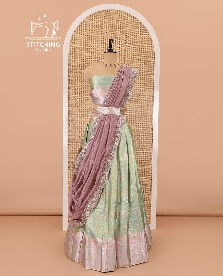 Pale green banarasi half-saree, floral jaal thread weave with contrast floral thread bordered skirt, a matching blouse, and scallop embroidered dhavani with belt
