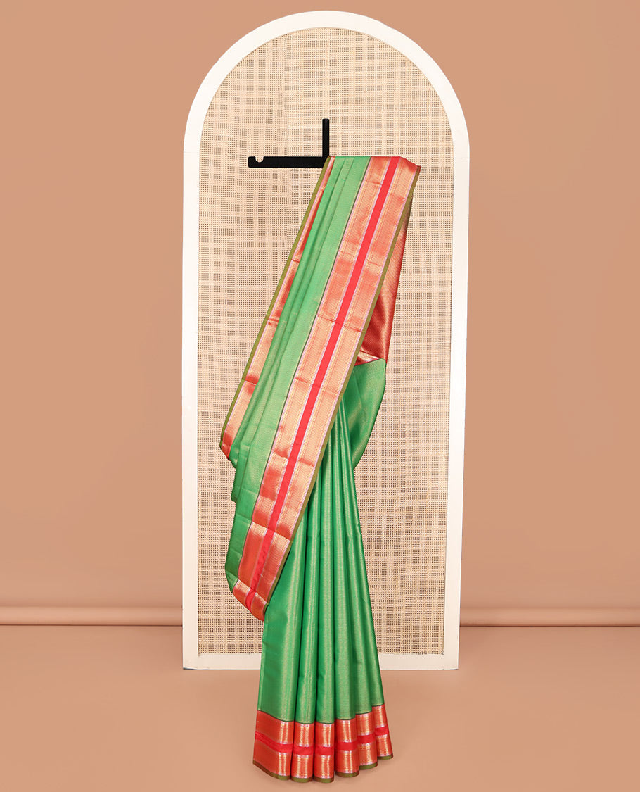 Green Vasundhara Lite Silk Mix Saree, Delicately Woven with Zari Stripes on Its Body, Complemented by a Contrast Rettai Pettu Border of Ara Bogudi, Paisa, Banaras, and Ara Maadam Designs, a Grand Pallu, and Paired with a Contrast Blouse