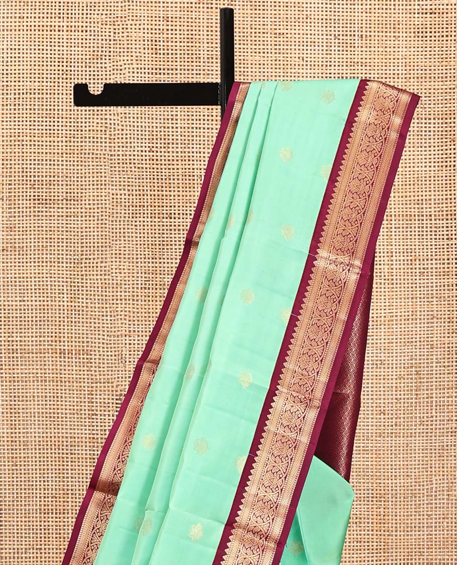 Light Turquoise Vasundhara Silk Saree, Sparsely Woven with Zari Buttas All Over Its Body, Complemented by a Contrast Border of Rekku, Muthu, Kathir, and Kodi Visiry Designs, Grand Jaal Pallu, and Paired with a Contrast Blouse