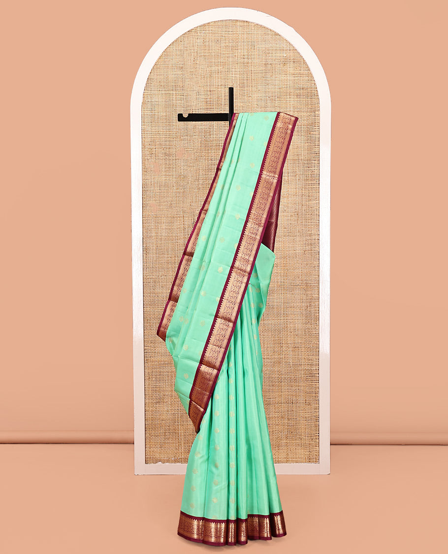 Light Turquoise Vasundhara Silk Saree, Sparsely Woven with Zari Buttas All Over Its Body, Complemented by a Contrast Border of Rekku, Muthu, Kathir, and Kodi Visiry Designs, Grand Jaal Pallu, and Paired with a Contrast Blouse
