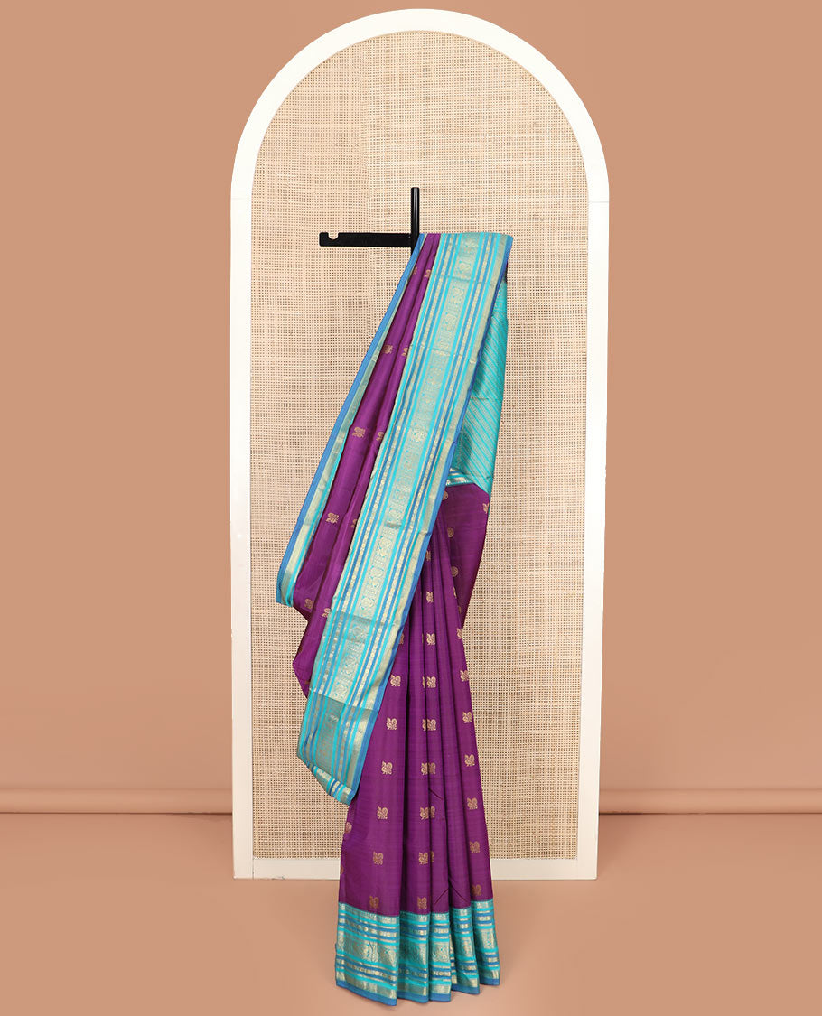 Purple Vasundhara Silk Saree Detailed with Mayil Chakram Buttas, Complemented by a Contrast Varisai Pettu Border of Rekku, Muthu, Kathir, Rudraksham, Mayil, and Mayil Kann Designs, Gleaming Pallu of Diagonal Stripes, and Paired with a Contrast Blouse