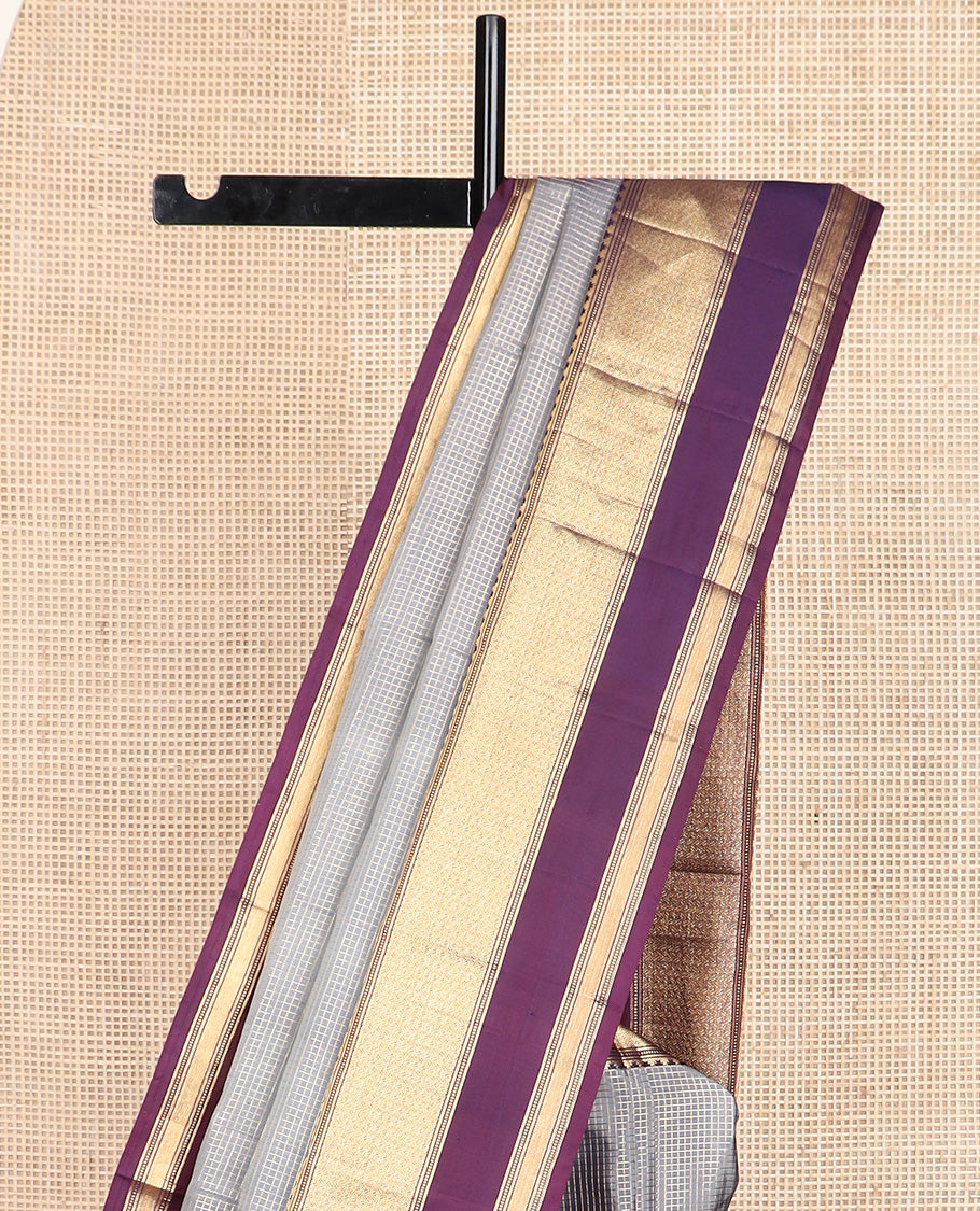 Grey micro-checked silk saree, contrast rettai pettu border of thazampoo rekku, banaras, muthu, and geometric designs, and jaal pallu