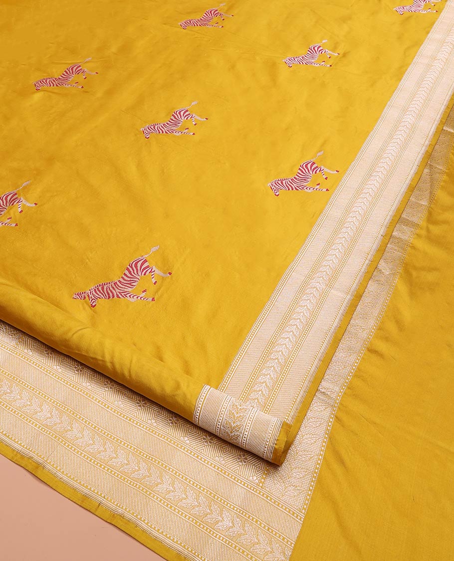 Yellow Banarasi Silk Saree Elevated with Zebra Motifs All Over Its Body, a Subtle Border of Traditional Designs, Pallu Decked Up with Floral and Diamond Designs, and Paired with a Matching Blouse