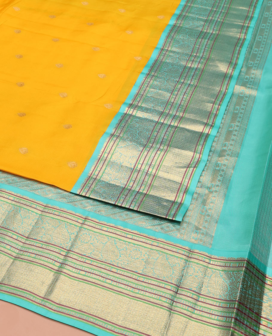 Yellow Vasundhara Silk Saree Decorated with Zari Buttas All Over Its Body, Complemented by a Contrast Border of Leaf, Rudraksham, Diamond, and Mayil Kann Designs, Pallu Featuring Manga Creeper Designs, and Paired with a Contrast Blouse