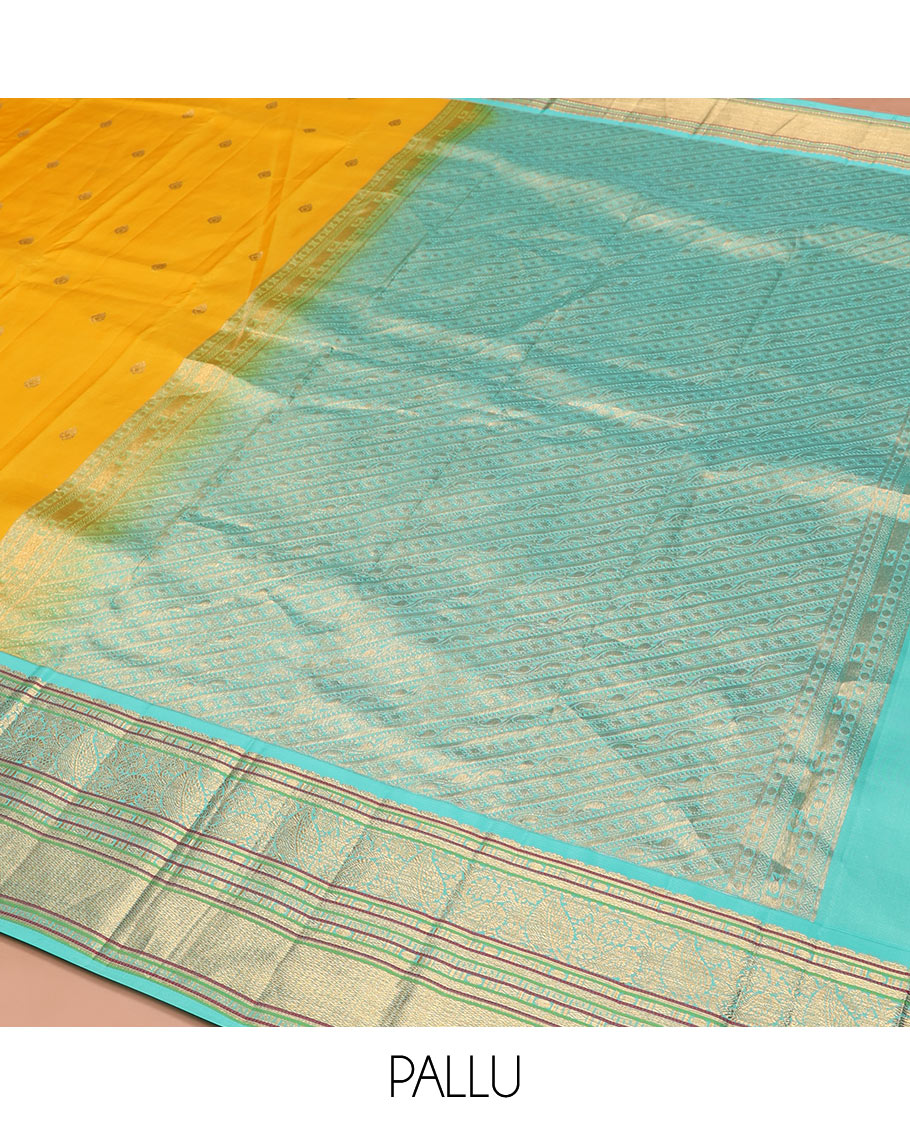 Yellow Vasundhara Silk Saree Decorated with Zari Buttas All Over Its Body, Complemented by a Contrast Border of Leaf, Rudraksham, Diamond, and Mayil Kann Designs, Pallu Featuring Manga Creeper Designs, and Paired with a Contrast Blouse