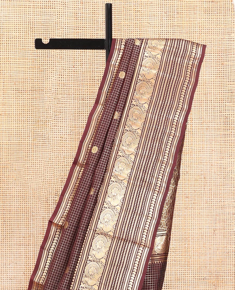 Brown Vasundhara Silk Saree, Masterfully Woven with Zari Buttas and Checks All Over Its Body, Highlighted by Zari Border of Rekku, Muthu, Kathir, Mayil, Neli, and Manga Designs, Grand Pallu, and Paired with a Contrast Blouse