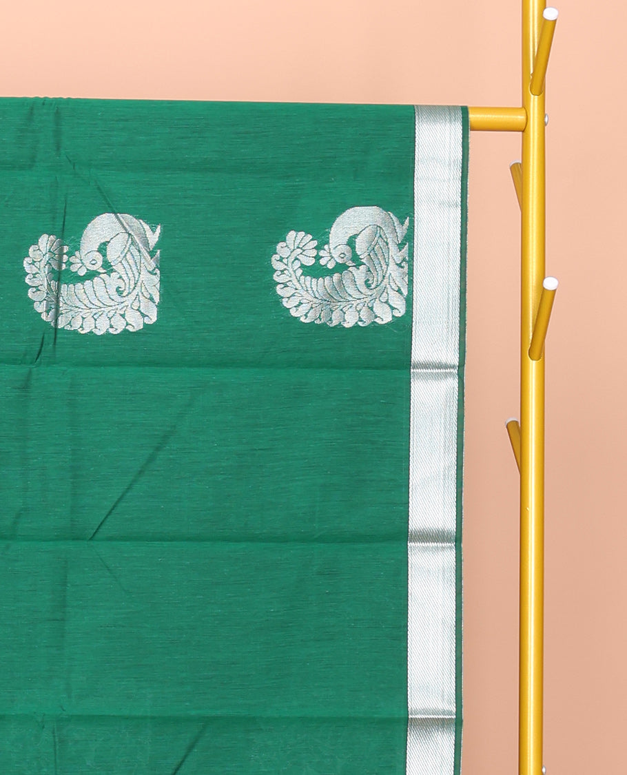 Green Semi-Silk Cotton Saree, Mesmerized with Peacock Buttas All Over Its Body, Highlighted by a Zari Border, Pallu Artfully Woven with Peacock Designs, and Paired with a Matching Blouse