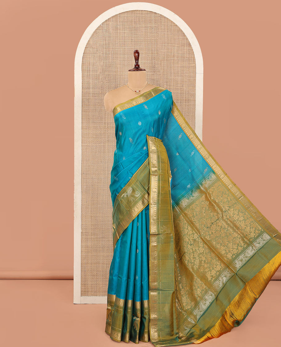 Blue Uppada Silk Saree Graced with Zari Buttas, Complemented by a Contrast Traditional Zari Border of Peacock Veena Designs, Contrast Pallu of Floral Jaal Designs, and Paired with a Contrast Blouse
