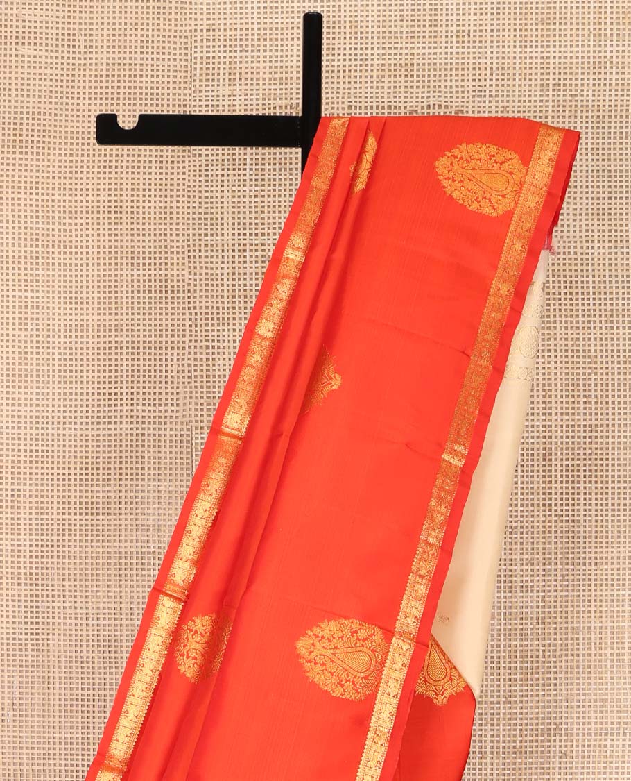 Orange Kanchipuram Silk Saree, Beautified with Zari Buttas All Over Its Body, Subtle Zari Piping Border, Complemented by a Contrast Pallu of Traditional Zari Designs, and Paired with a Contrast Blouse